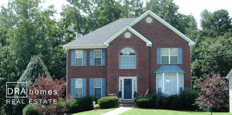 Pennington Hill Marietta 30064 | Brick front home on a basement on a green lawn } DRA Homes Real Estate watermark