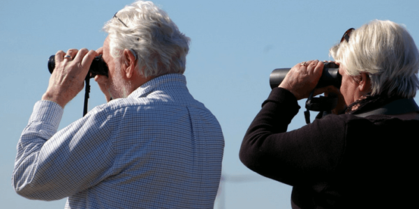 Senior Couple Using Binoculars Slider